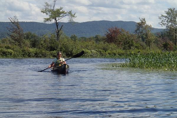 Solo paddler on Raquette River near Tupper Lake