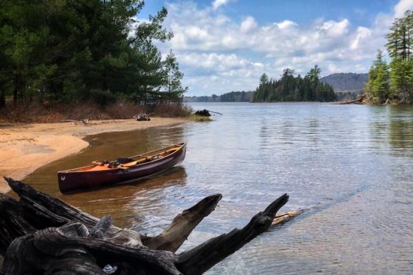 solo canoe on shore of lake