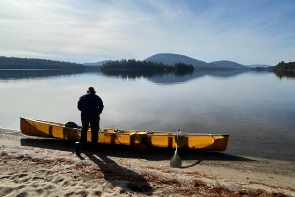 Canoe with person at campsite on Long Lake