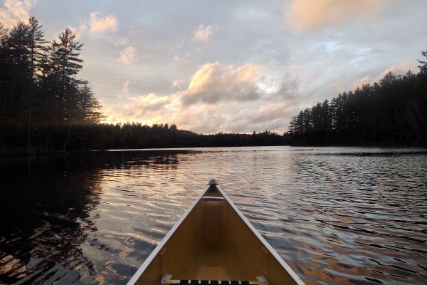 canoeing on pond at sunset