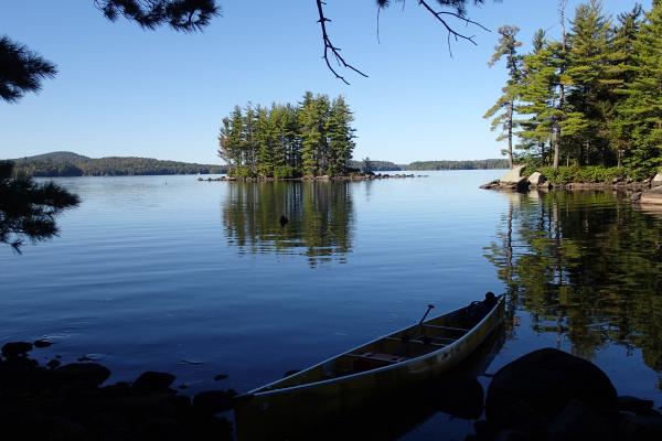 canoe along campsite shore looking out at island